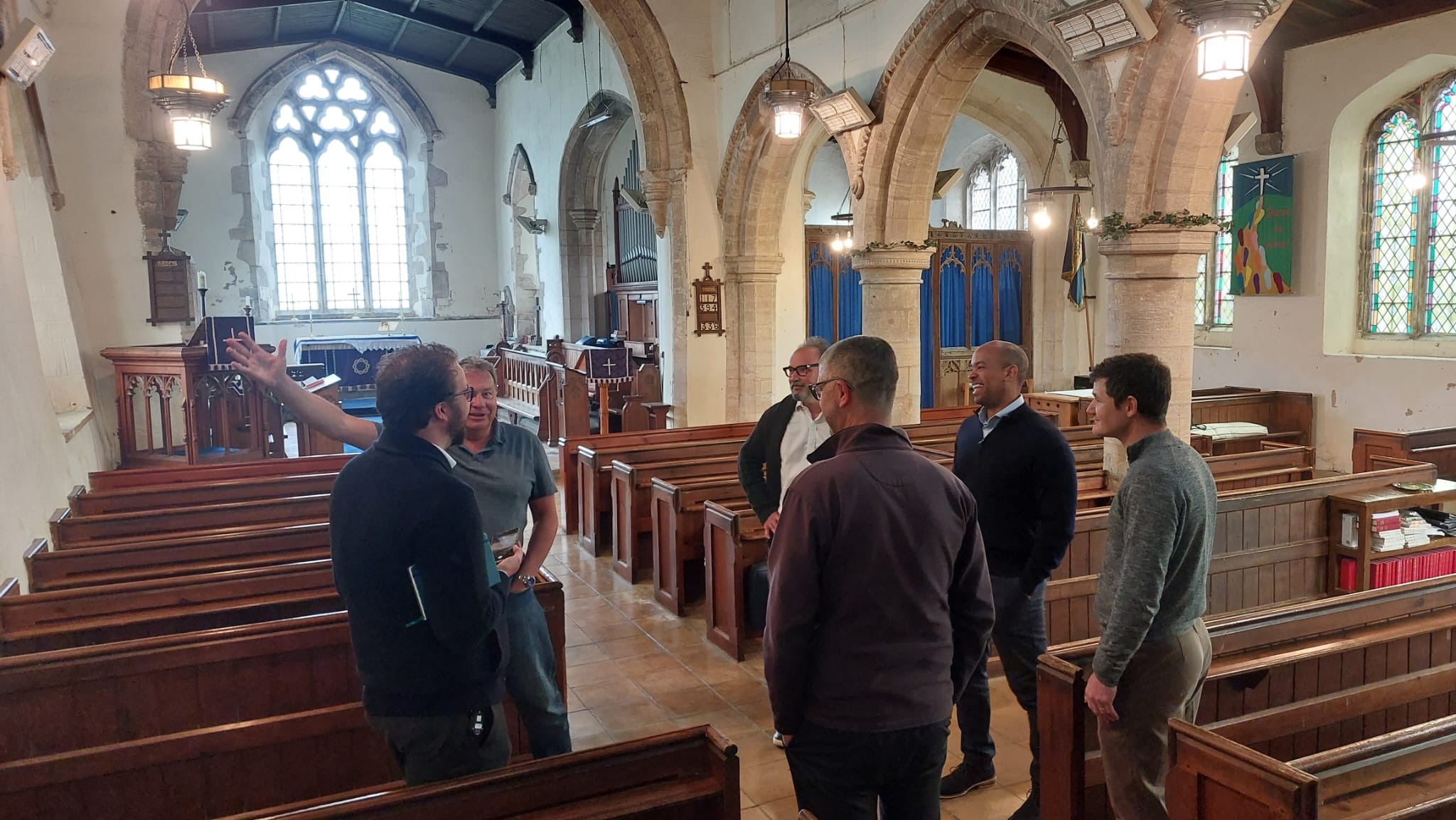 Photo of Ben Obese-Jecty and Spaldwick Common Ground committee discussing the project inside St James Church Spaldwick
